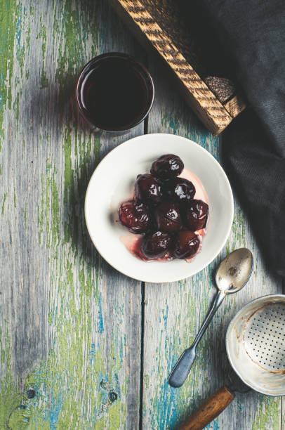Pickled plum on a white plate over old wooden table