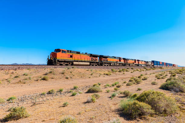 Freight Train driving through Mojave Desert California Freight Train driving through Mojave Desert along Route 66, California, USA. mojave desert stock pictures, royalty-free photos & images