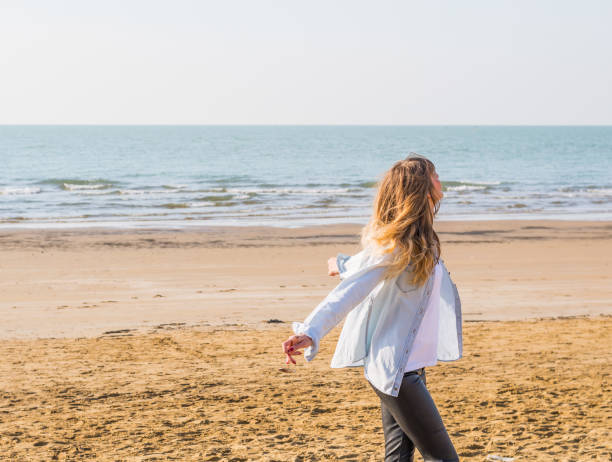 istock girl enjoying sun at the beach 683074514
