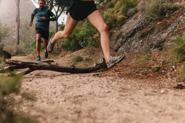 istock Young people running on country trail path 683074680