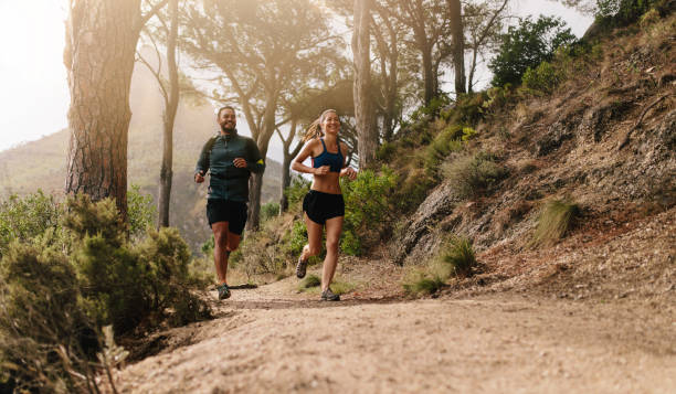 istock Young sporty couple running in the mountains 683074758