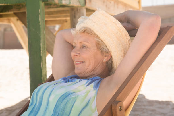 istock Close up of senior woman looking away while relaxing on chair 683076990