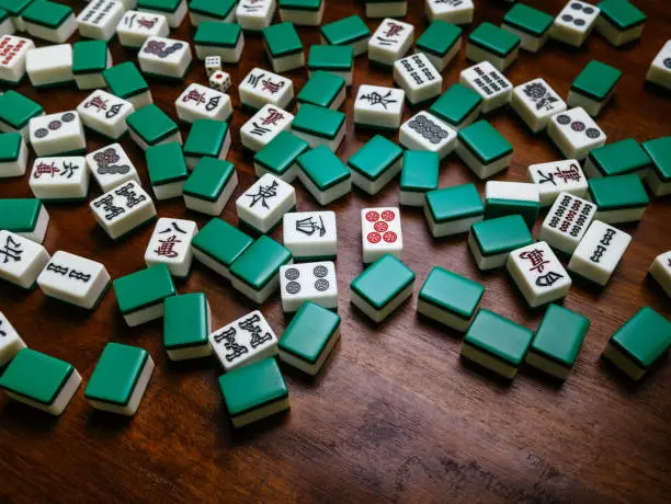Full of Mahjong tiles on wood table background