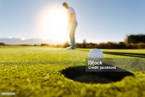 Man Puts The Ball On Golf Course Green Stock Photo - Download Image Now - Golf, Golf Course, Golfer