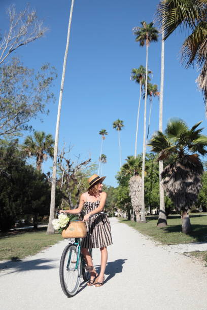 istock Woman riding bicycle in a tropical park. 683087472