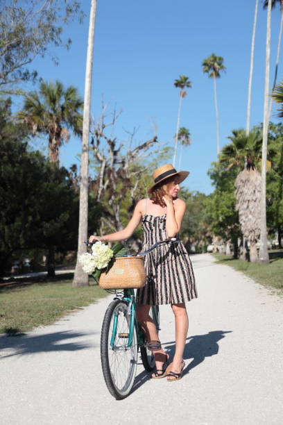 istock Woman riding bicycle in a tropical park. 683087766