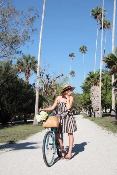 istock Woman riding bicycle in a tropical park. 683090754