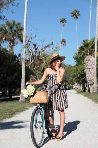 istock Woman riding bicycle in a tropical park. 683090870