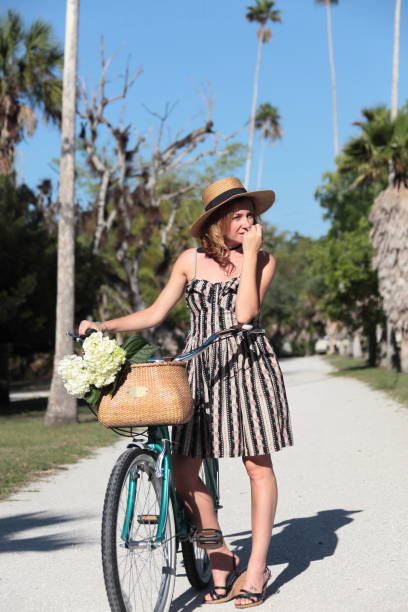 istock Woman riding bicycle in a tropical park. 683091082