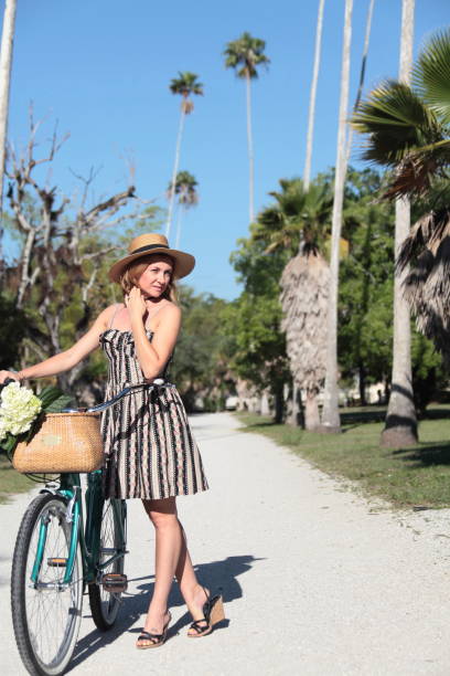 istock Woman riding bicycle in a tropical park. 683097696