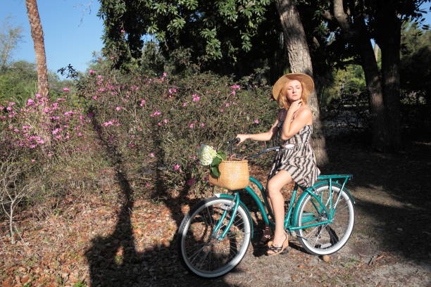 istock Woman riding bicycle in a tropical park. 683098008
