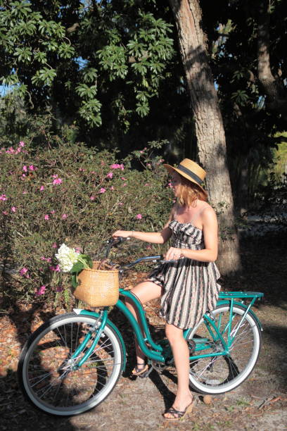 istock Woman riding bicycle in a tropical park. 683098272