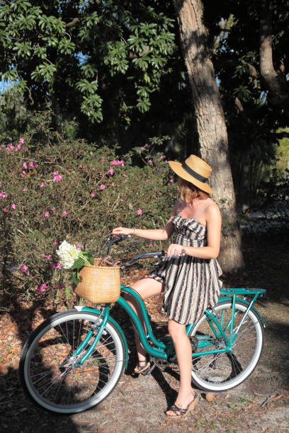 istock Woman riding bicycle in a tropical park. 683098906