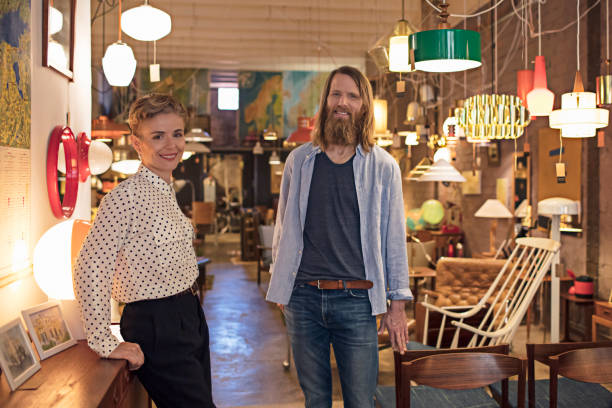 istock Confident store owners standing amidst furniture 683103994