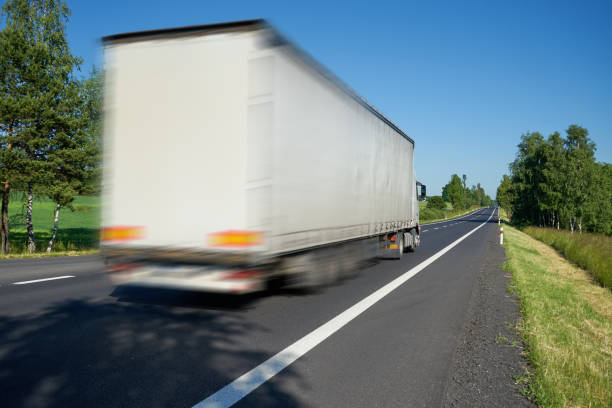 istock Motion blurred white truck driving on the road a landscape 683105366