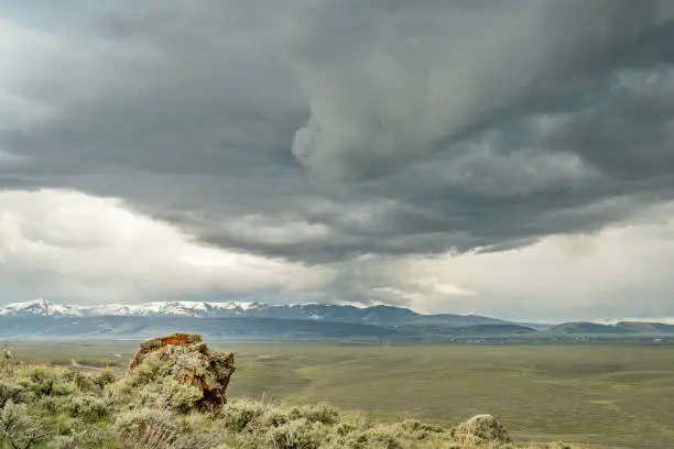heavy storm clouds over Colorado's North Park with Park Range of Rocky Mountains in distance, spring scenery