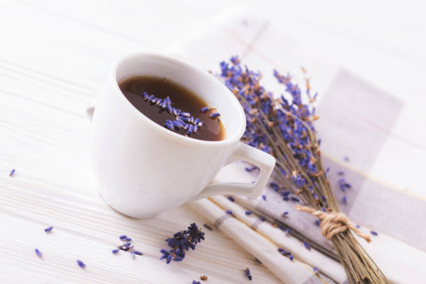 istock Cup of coffee with lavender flowers on table 683109112