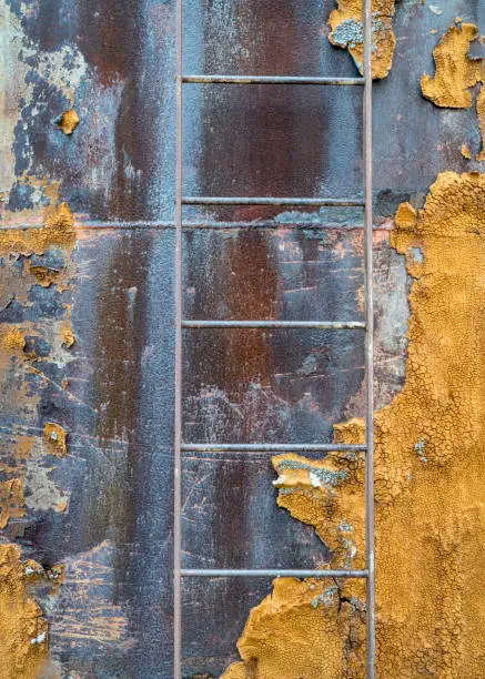 metal ladder on old water tank covered by lichen in eastern Utah desert
