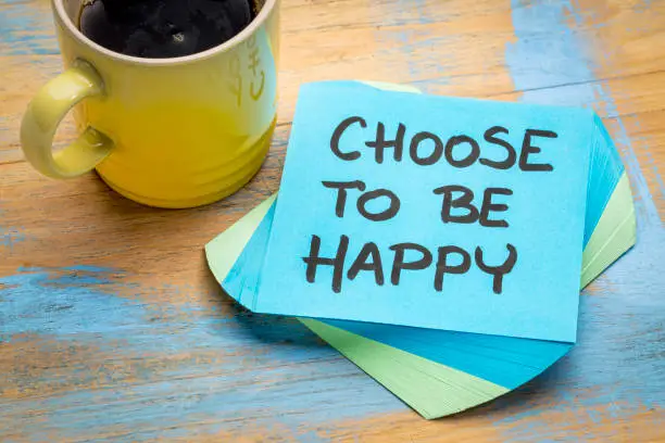 choose to be happy advice or reminder  - handwriting on  a sticky note with a cup of coffee