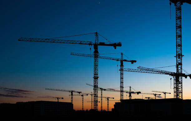 istock many construction cranes on sunset sky , crane silhouette skyline 683115114