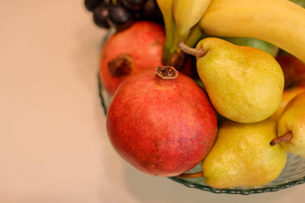 fruits in an arrangement on a white wooden surface with a white background. Top view