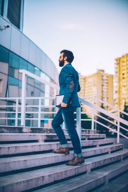 istock Young formal wear businessman carrying a digital tablet and getting to work 683122456