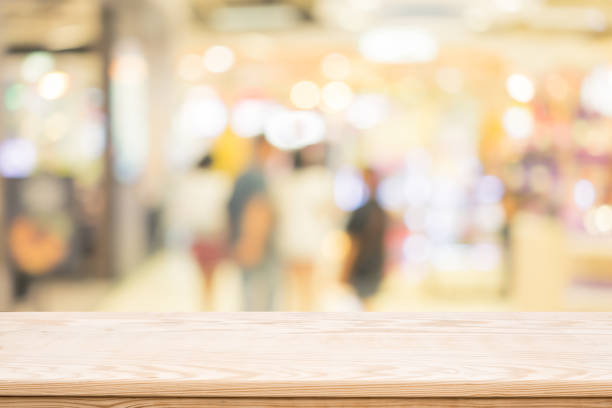istock wood coordination table top on shopping mall blurred background,Space available for the product 683136406