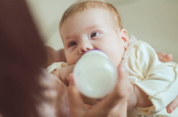istock A young mother, feeding the child 683155828