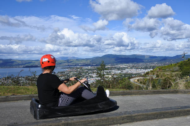 Man ride on Skyline Rotorua Luge Rotorua: Man rides on the Skyline Rotorua Luge. Skyline Luge is a gravity fuelled fun ride. Invented in New Zealand in 1985, and having hosted over 30 million rides worldwide. rotorua luge stock pictures, royalty-free photos & images