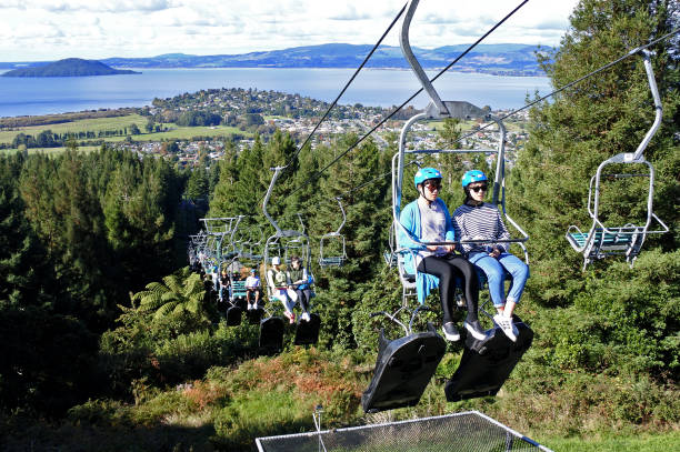 Skyline Rotorua Luge New Zealand Rotorua: People ride on the Skyline Rotorua Luge ride in Rotorua, North Island, New Zealand. Skyline Luge is a gravity fuelled fun ride. Invented in New Zealand in 1985, and having hosted over 30 million rides worldwide. rotorua luge stock pictures, royalty-free photos & images
