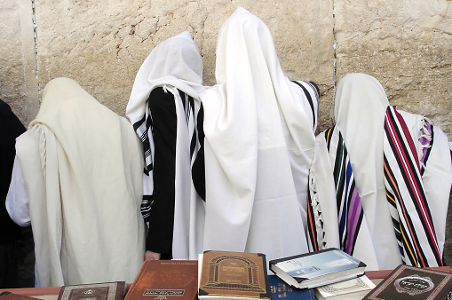 Orthodox Jewish men Pray at the Western Wall during the Jewish holiday of Passover in Jerusalem, Israel. Passover commemorates the liberation of the Israelites from Egyptian slavery