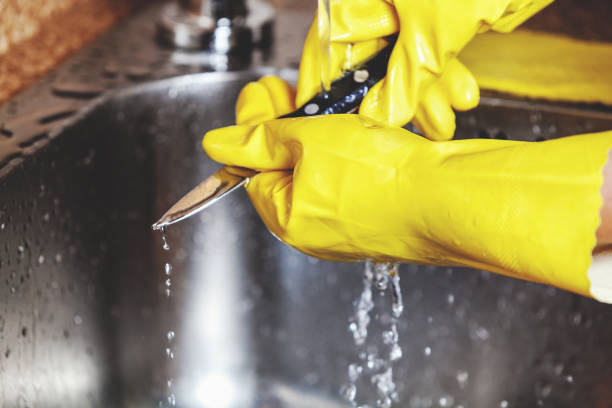 istock Hands in yellow rubber gloves, wash small knife 683188126