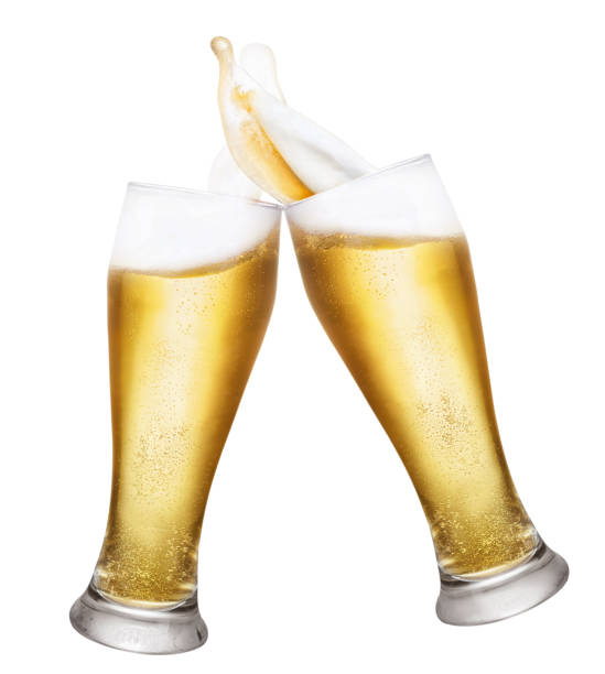 two glasses of beer with splashes two glasses of beer toasting creating splashes isolated on white background. Pair of beer glasses making toast. Glasses with beer up. Golden beer splash beer glass splash stock pictures, royalty-free photos & images