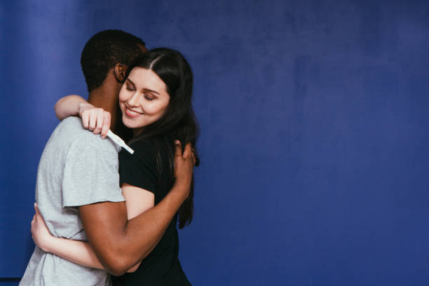 istock Pregnancy test, positive. Happy future parents hug 683212252