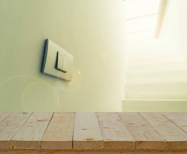 istock abstract wood table top and lighting switch on wall with lens fare filter 683215040