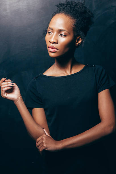 istock Young african woman in black posing to camera 683215398