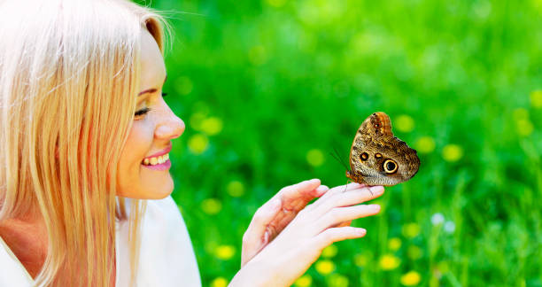 istock Woman playing with a butterfly 683219824
