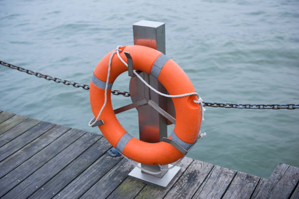 istock Life preserver on dock overlooking sea water 683222914