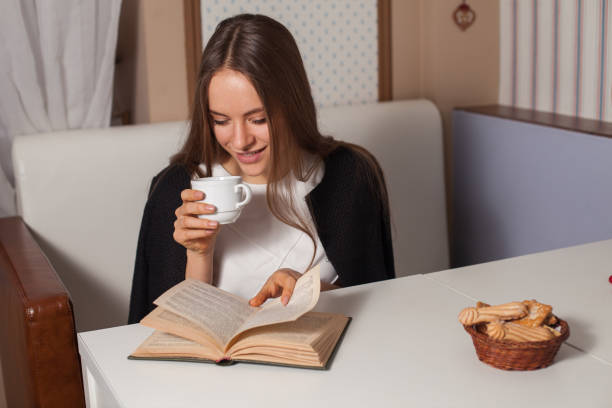 istock Woman with book and tea 683223412