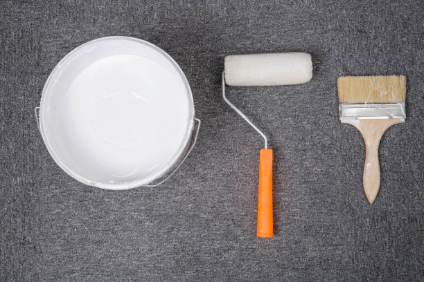 istock White plastic bucket and brush, roller, on the floor. 683230218