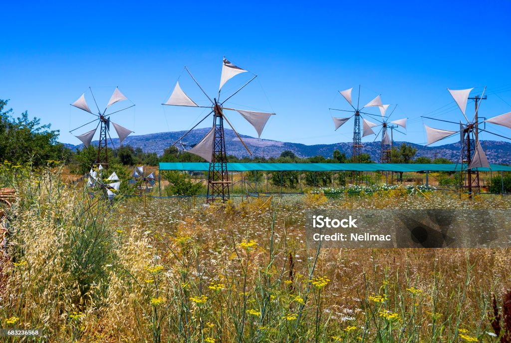 Old rusty windmills on the field. Agriculture in Greece, Crete Old windmills on the Lassithi Plateau on Crete, Greece Lasithi Stock Photo