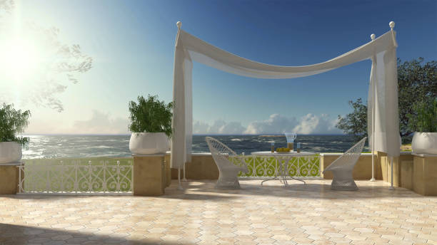 istock Empty classic terrace with canopy relax area, armchairs and table for breakfast, panoramic on rough sea ocean and olives trees 683249652