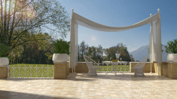Empty classic terrace with canopy relax area, armchairs and table for breakfast, panoramic garden meadow