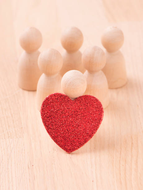 istock Group of figures holding red heart 683253980