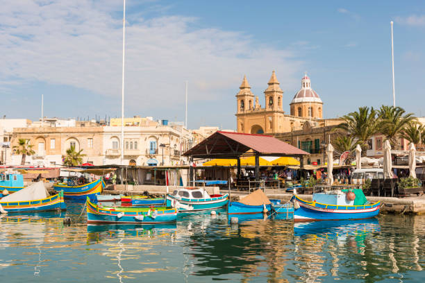 Colorful small fishermans boats in Marsaxlokk harbor in Malta.