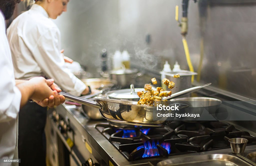 Chef preparing cuisine in hotel kitchen Chef Stock Photo