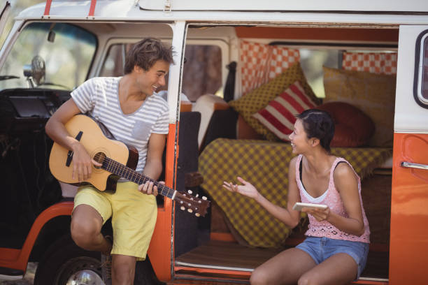 istock Happy friends enjoying while sitting in motor home 683264884