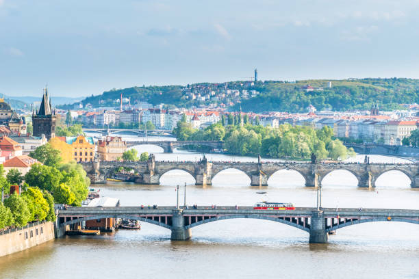istock Red tram on the bridge through Vltava river in Prague, Czech Republic 683271580