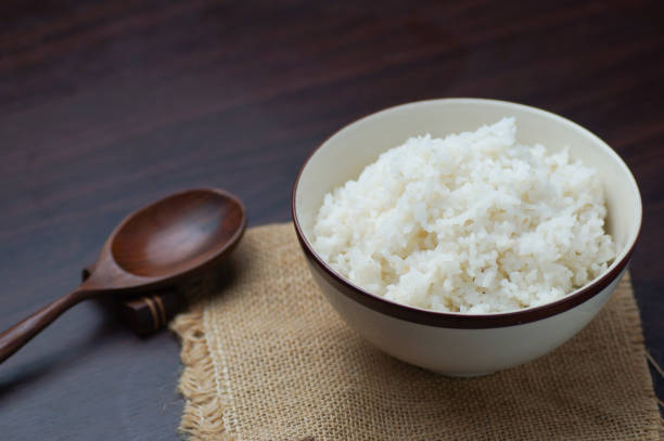 istock Thai rice in bowl with wooden spoon on table 683271802