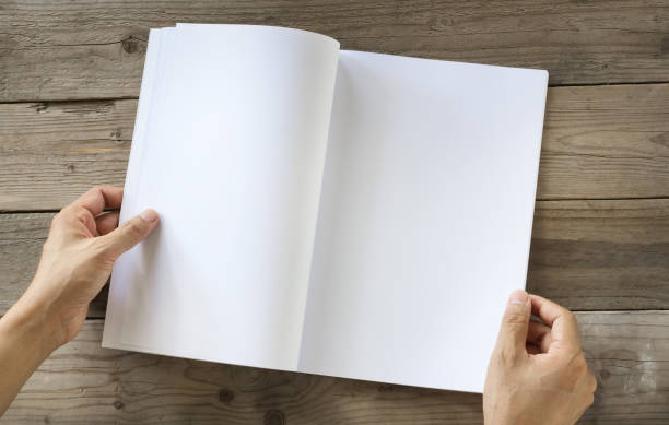 Hands open Blank catalog, magazines,book mock up on wood table
